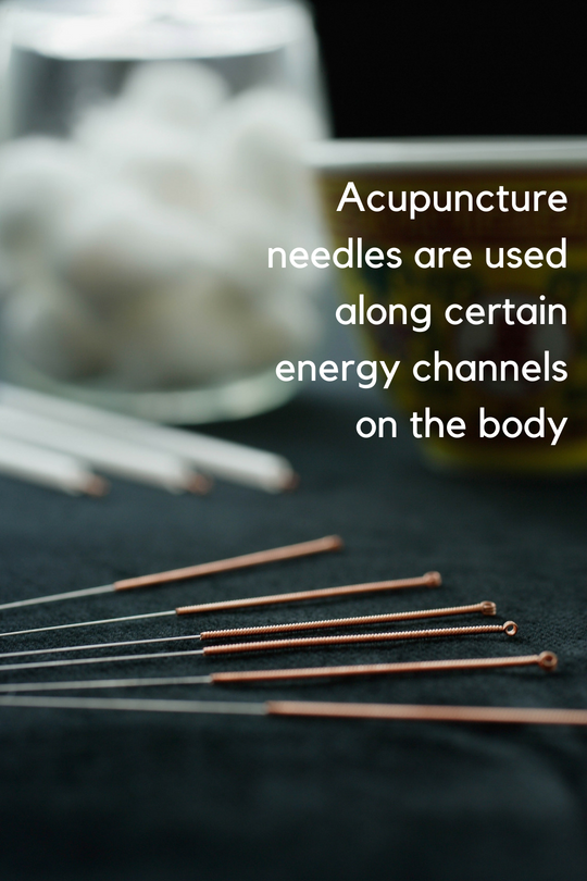 Acupuncture needles are used along certain energy channels on the body