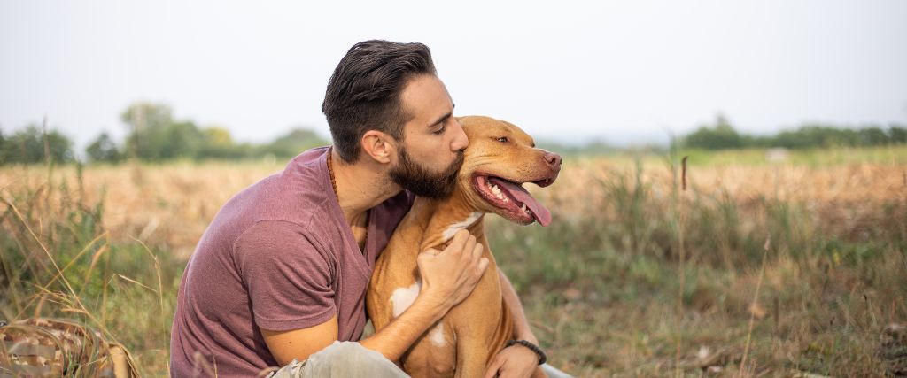 Man kissing happy dog